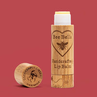 Door County Cherry natural beeswax lip balm on cherry red background