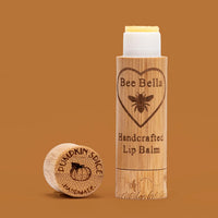 Pumpkin Spice natural beeswax lip balm on autumn orange color background
